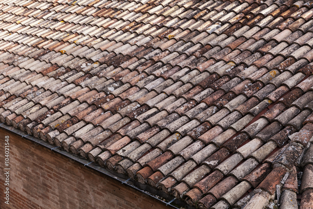 Old weathered red tile roof close-up photo Old weathered red tile roof close-up photo