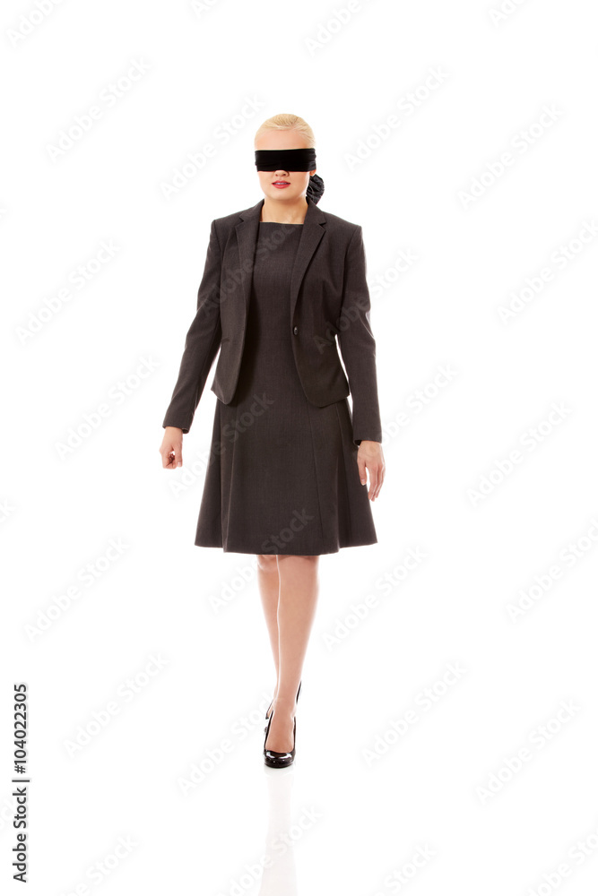 Beautiful young blindfolded businesswoman trying walk Beautiful young blindfolded businesswoman trying walk