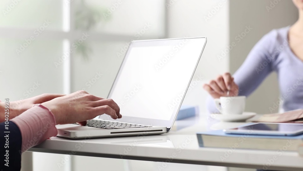 Young girls sitting at desk, studying and using a laptop, communication and learning concept, hands close up, seamless loop Young girls sitting at desk, studying and using a laptop, communication and learning concept, hands close up, seamless loop