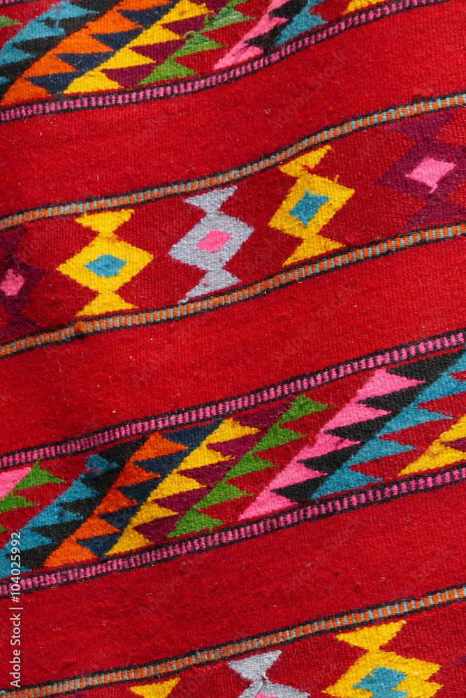 Hand made rug. Colorful surface, texture of traditional woolen a Hand made rug. Colorful surface, texture of traditional woolen a