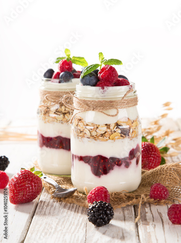 Tasty yoghurts with muesli, fresh berries and jam.