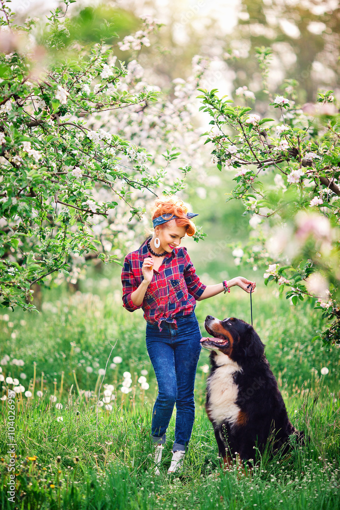 woman girl with dog bern in spring garden, 