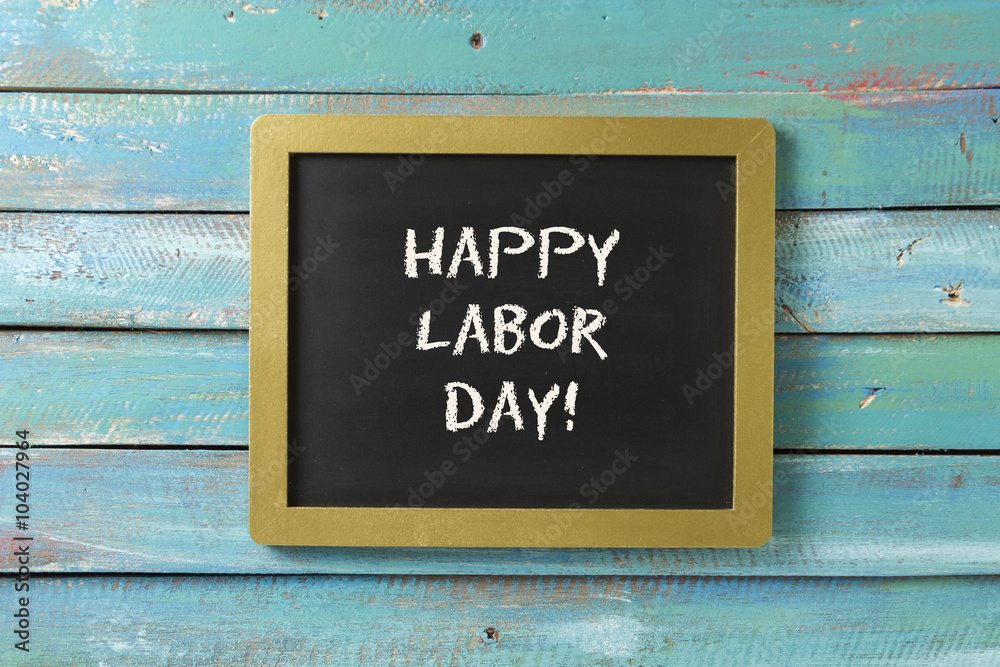 Labor Day chalk sign on blue wood background Labor Day chalk sign on blue wood background
