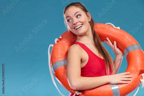 Lifeguard woman on duty with ring buoy lifebuoy.