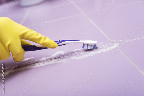 Clean the tile with a toothbrush.