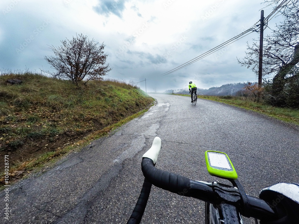 Fototapeta premium cyclist are training on a rainy day. Pov, original point of view