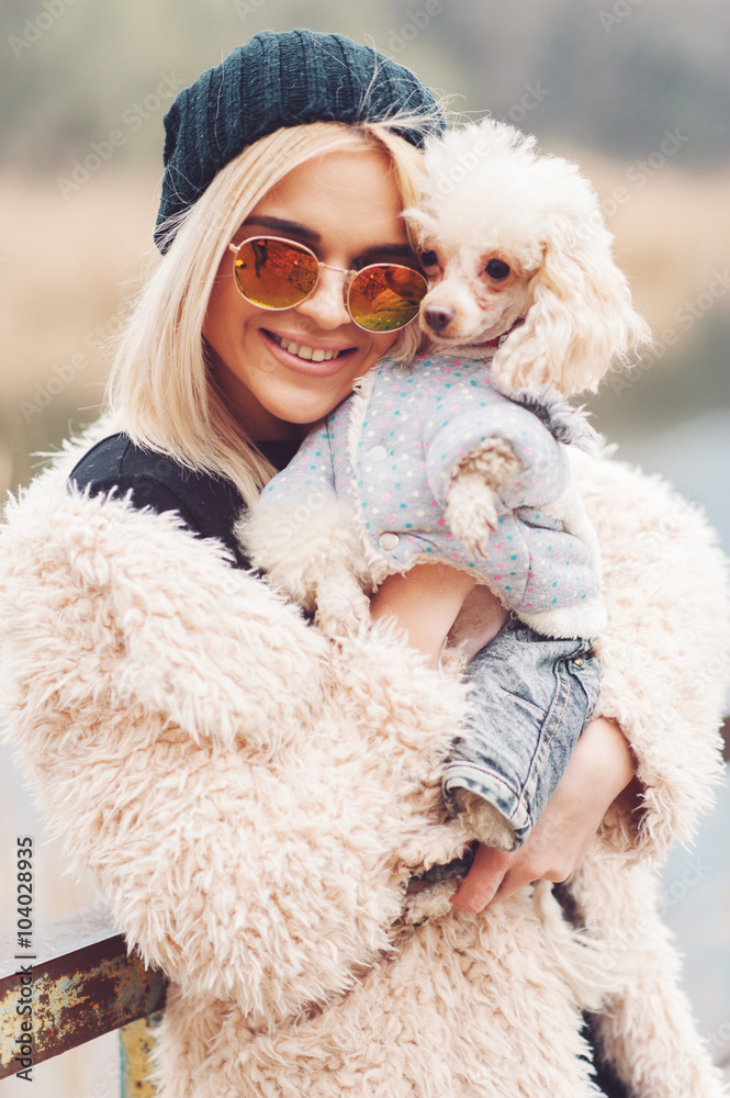 young caucasian cute girl portrait with dog outdoor in park walking happy and smile all the way
