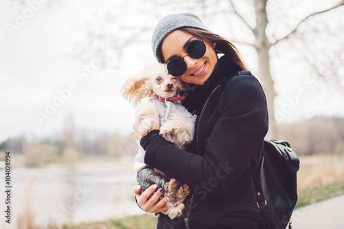 young caucasian cute girl portrait with dog outdoor in park walking happy and smile all the way

