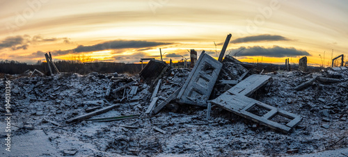 Nuclear winter.The remains of destroyed houses covered with snow at sunset