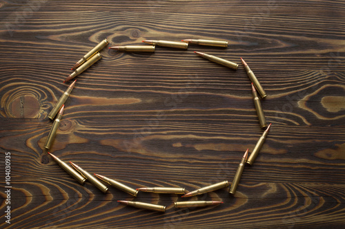 Bullets for hunting on the wooden background