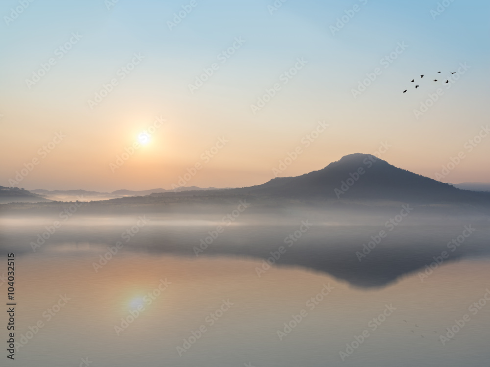 beautiful sunrise and mountain with Water Reflection.