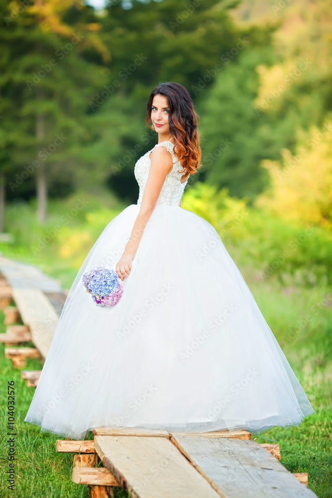 Beautiful bride in wedding dress and bridal bouquet, happy newly Beautiful bride in wedding dress and bridal bouquet, happy newly