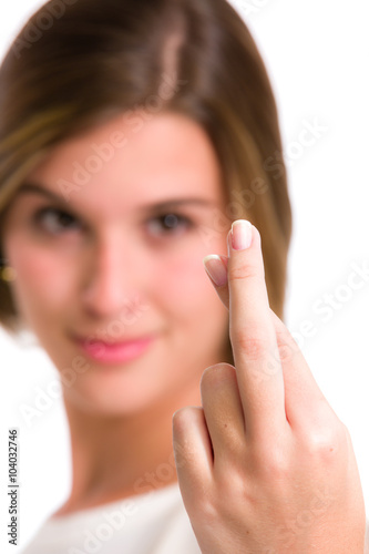 Hispanic young woman wishing luck with fingers crossed. Close-up view.