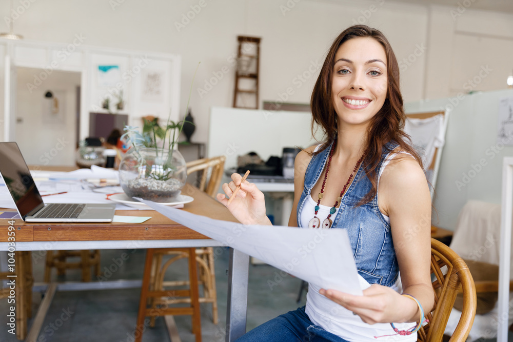 Young woman standing in creative office