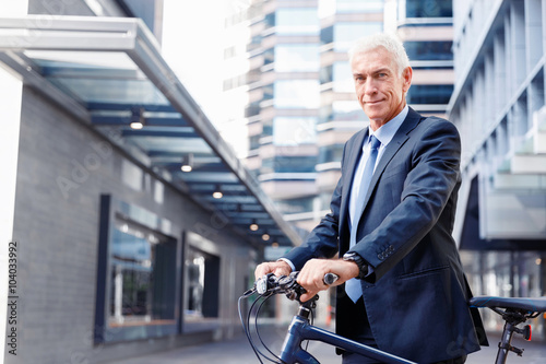 Successful businessman riding bicycle