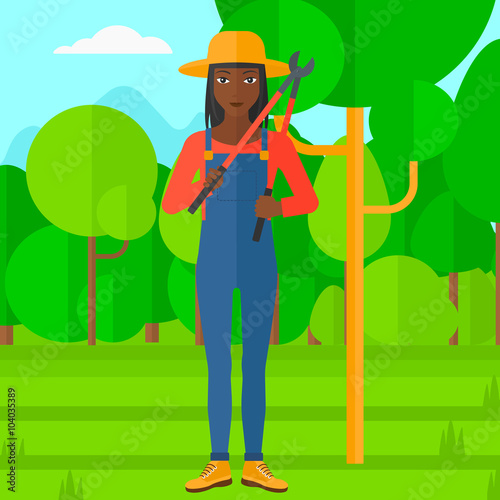 Farmer with pruner in garden.