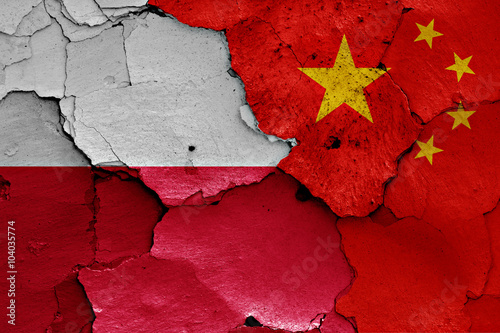 flags of Poland and China painted on cracked wall