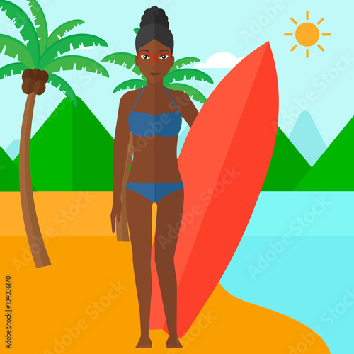 Surfer holding surfboard.