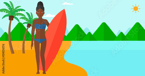 Surfer holding surfboard.