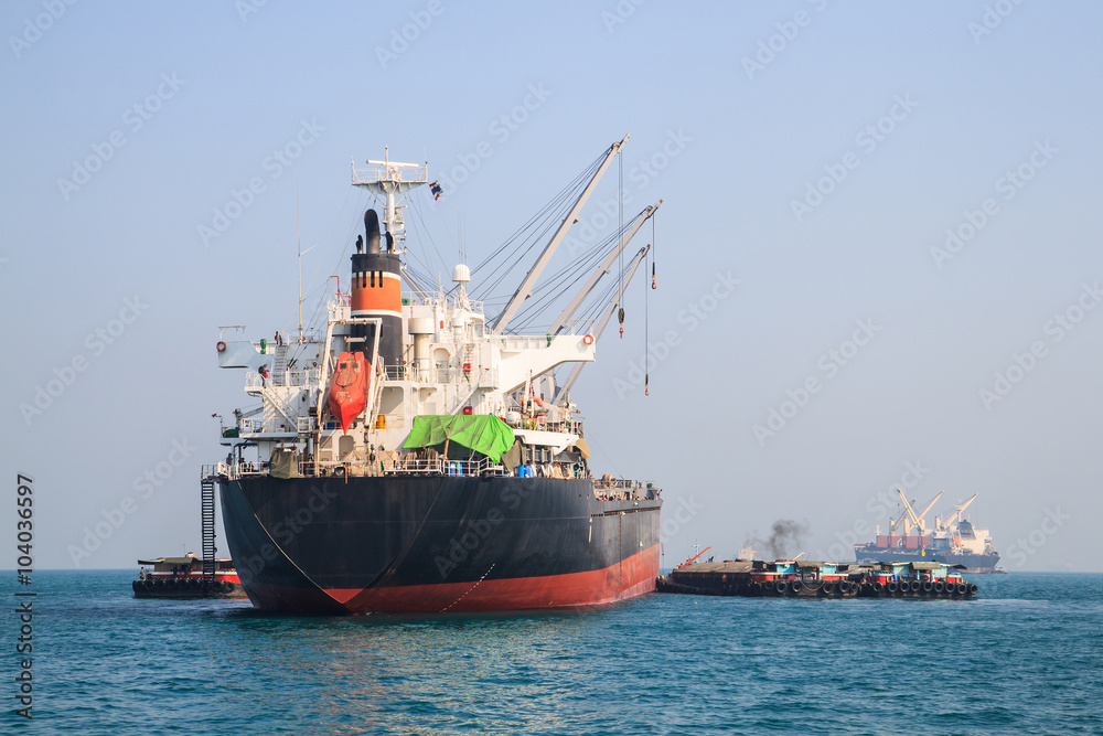 Big cargo ship sails on the Sea.