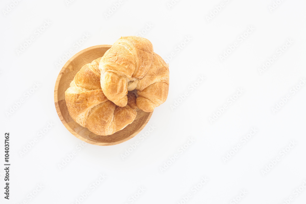 Croissants in wood plate on white background