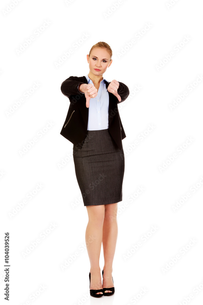 Unhappy businesswoman with thumbs down gesture Unhappy businesswoman with thumbs down gesture