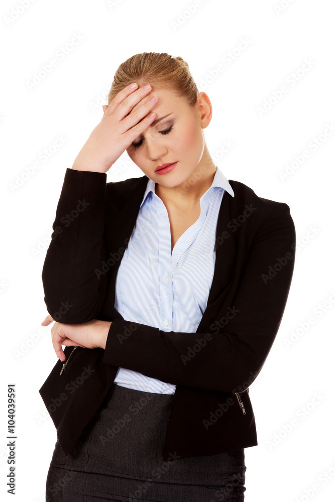 Business woman with a huge headache holding head Business woman with a huge headache holding head