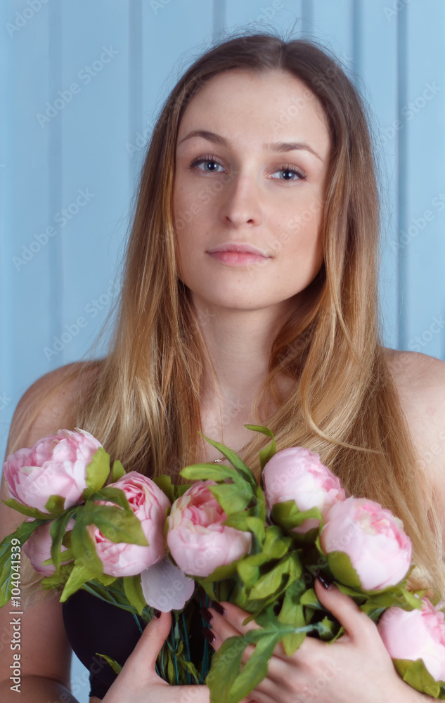 Beautiful close-up portrait of a young woman with peonies Beautiful close-up portrait of a young woman with peonies