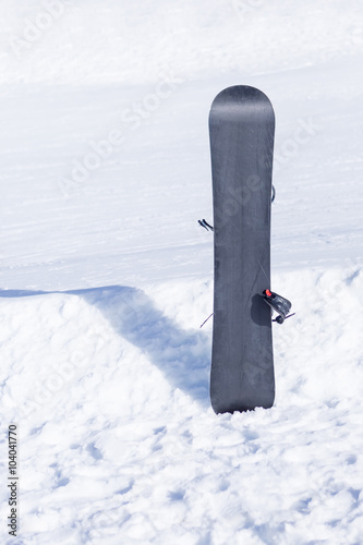 Snowboard on white snow