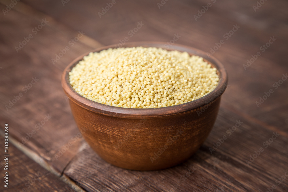 hulled millet on a dark background hulled millet on a dark background