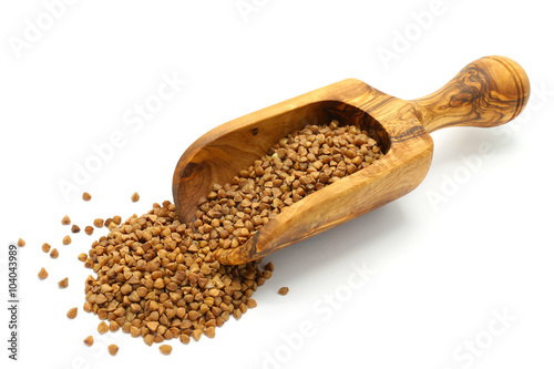 Buckwheat grains in wooden scoop