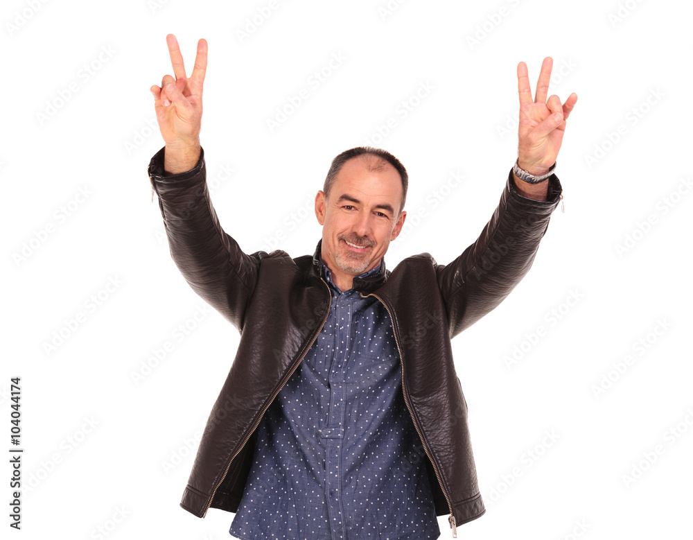 man in leather jacket showing the victory sign man in leather jacket showing the victory sign