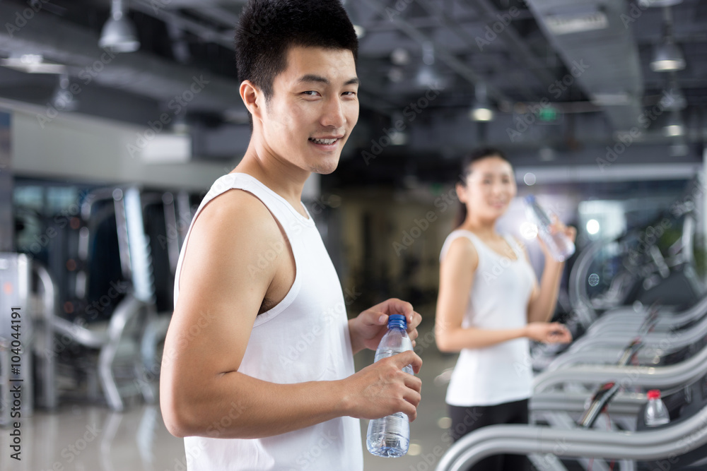 young people working out in modern gym young people working out in modern gym