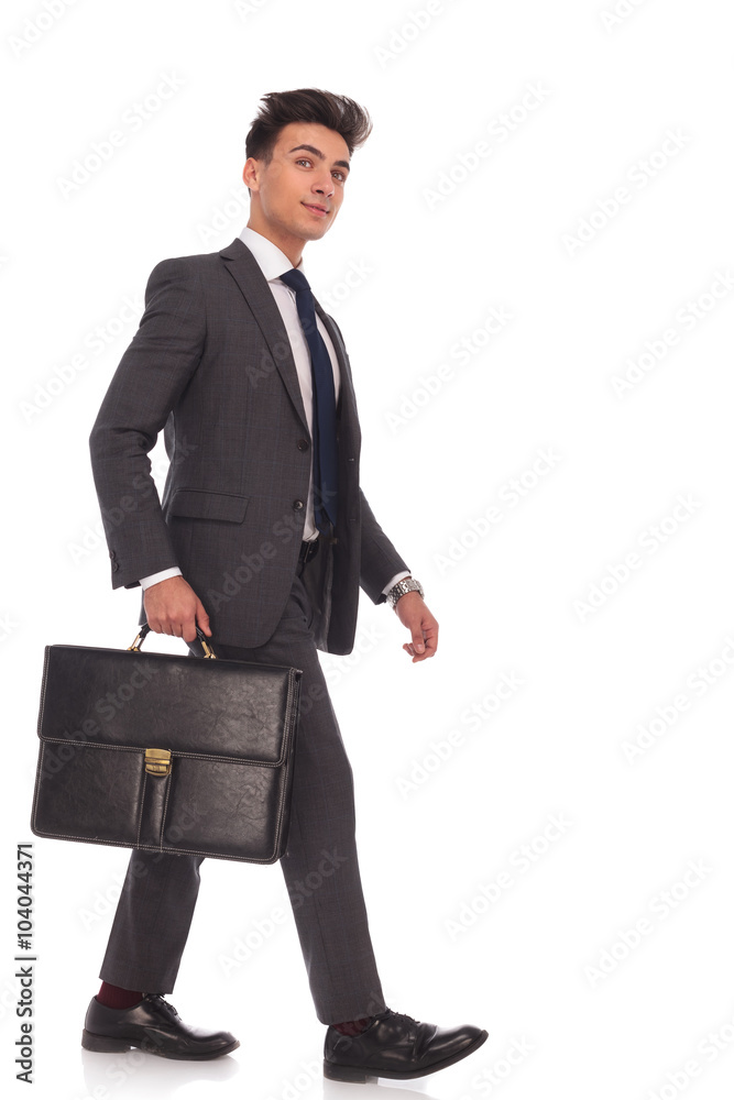 smiling young business man walking forward and looking up smiling young business man walking forward and looking up