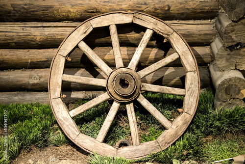 Old wooden coach wheel near barn © artbox_of_life