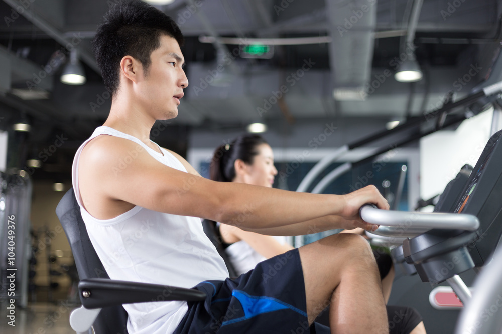young people working out in modern gym young people working out in modern gym