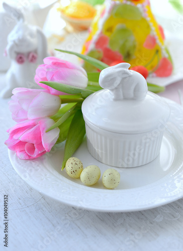 Place setting with Easter dessert at the background