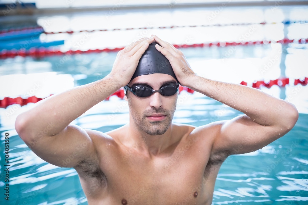 Handsome man wearing swim cap and goggles