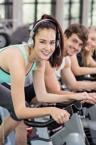 Fit group of people using exercise bike together