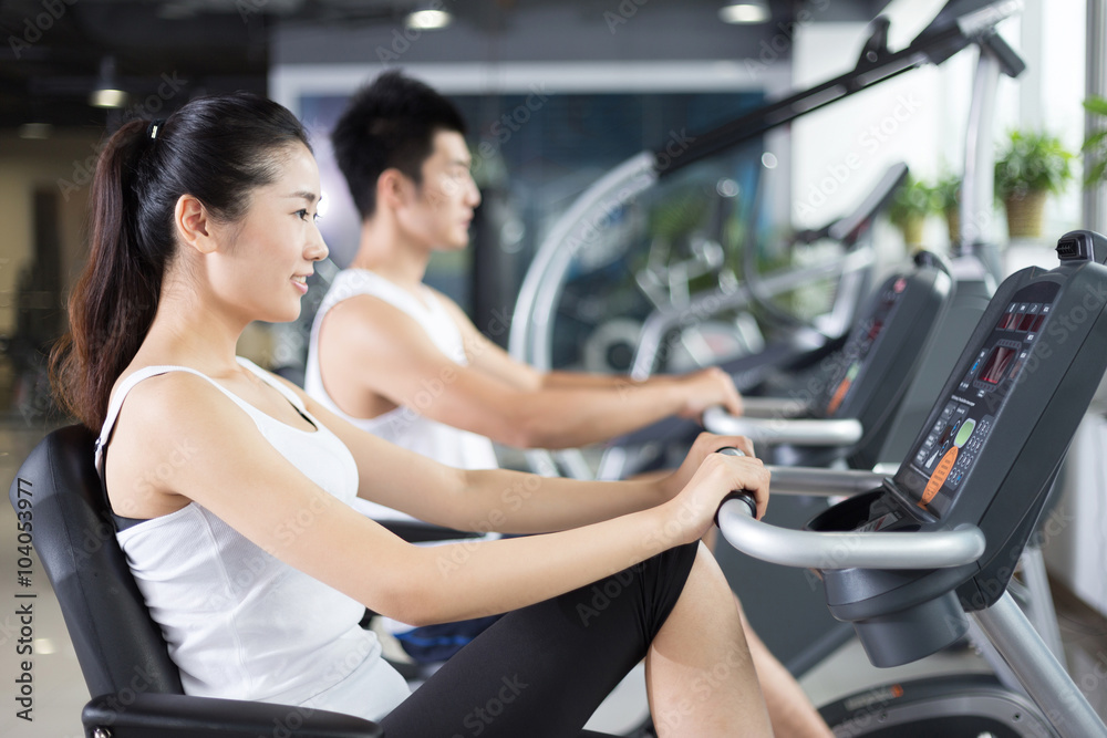 young people working out in modern gym young people working out in modern gym