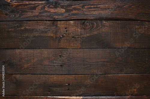 Dark brown rustic aged barn wood planks background. Space for text, copy, lettering.