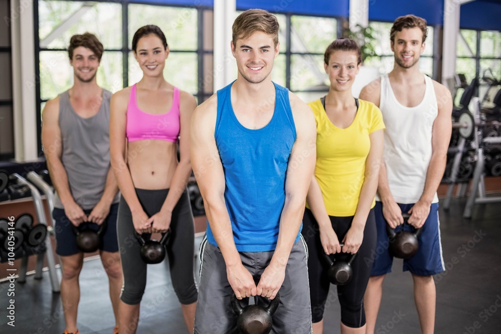 Fitness class lifting dumbbells