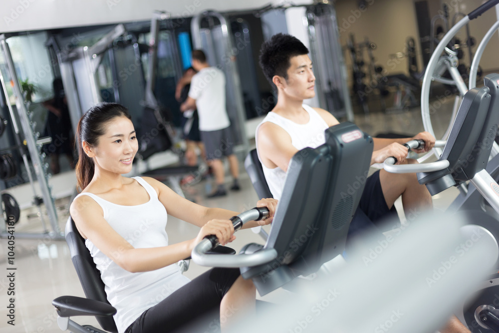 young people working out in modern gym young people working out in modern gym