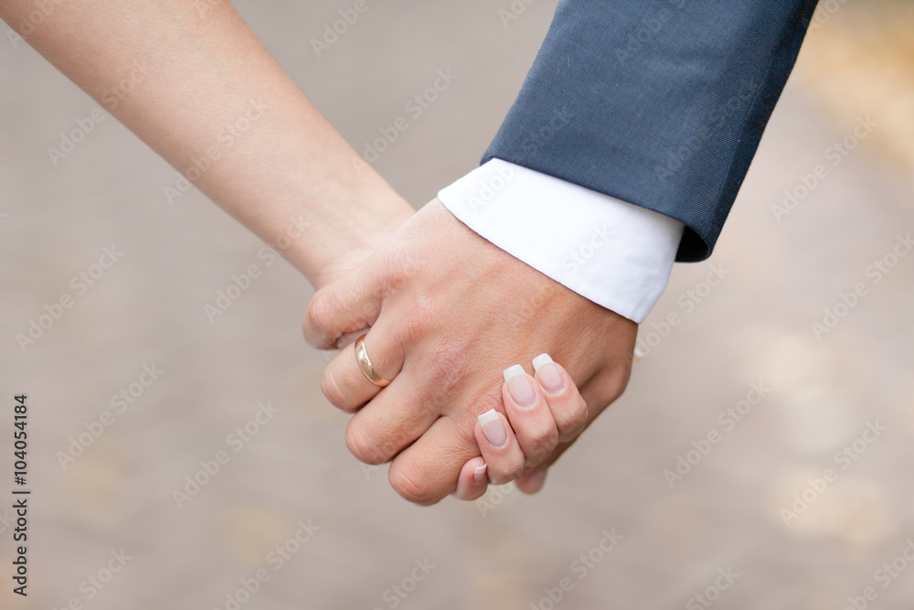 Male and female hands together.