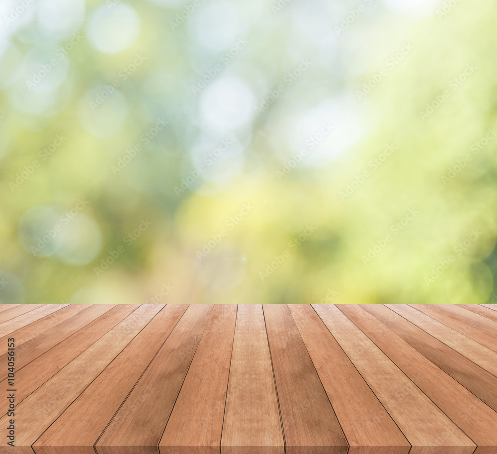 Wooden table top on blurred green background - used for display your products Wooden table top on blurred green background - used for display your products