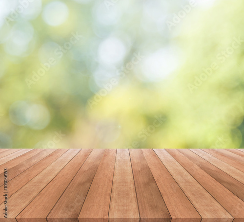 Wooden table top on blurred green background - used for display your products