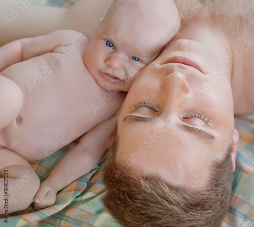 Handsome young manand his newborn son . Fatherly love photo