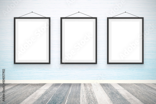 Blank picture frames on the wooden wall room
