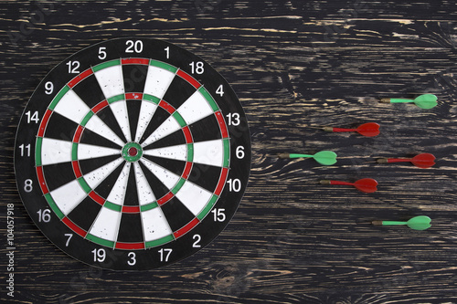The darts isolated on wooden background