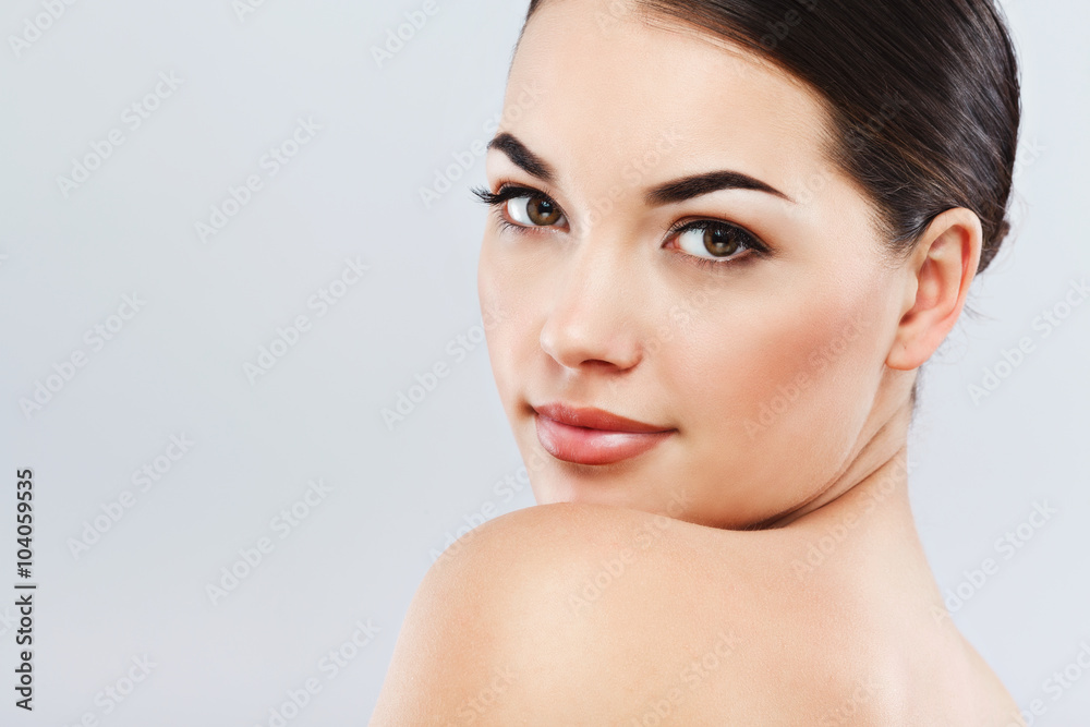 Gorgeous girl with dark hair at gray studio background Gorgeous girl with dark hair at gray studio background